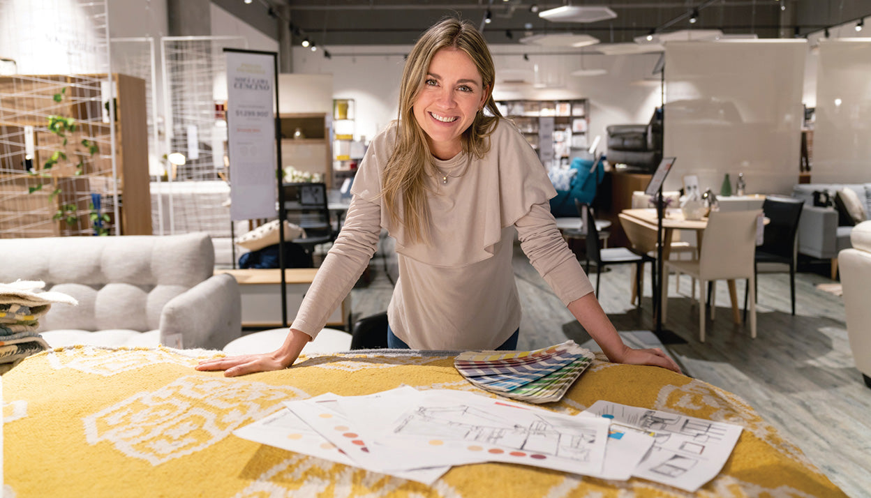 Portrait of a happy interior designer working on a home design at a furniture store and looking at the camera smiling.