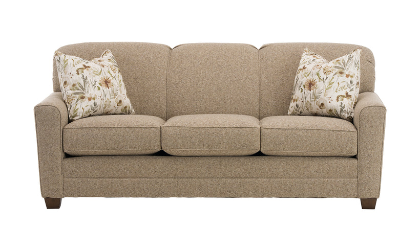 Beige sofa with floral-patterned cushions on a white background