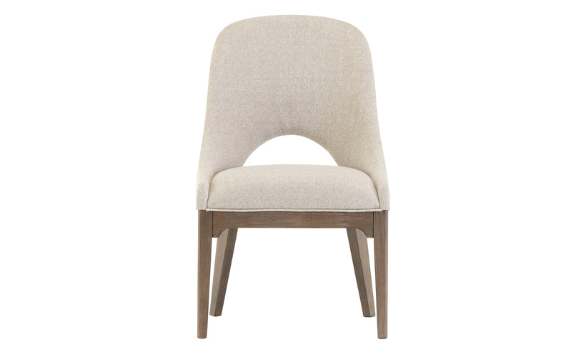 Neutral upholstered dining chair with a curved back on a white background.